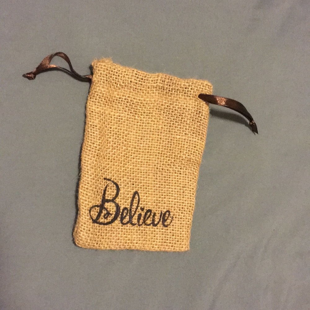 Small wristlet bag that says “believe”